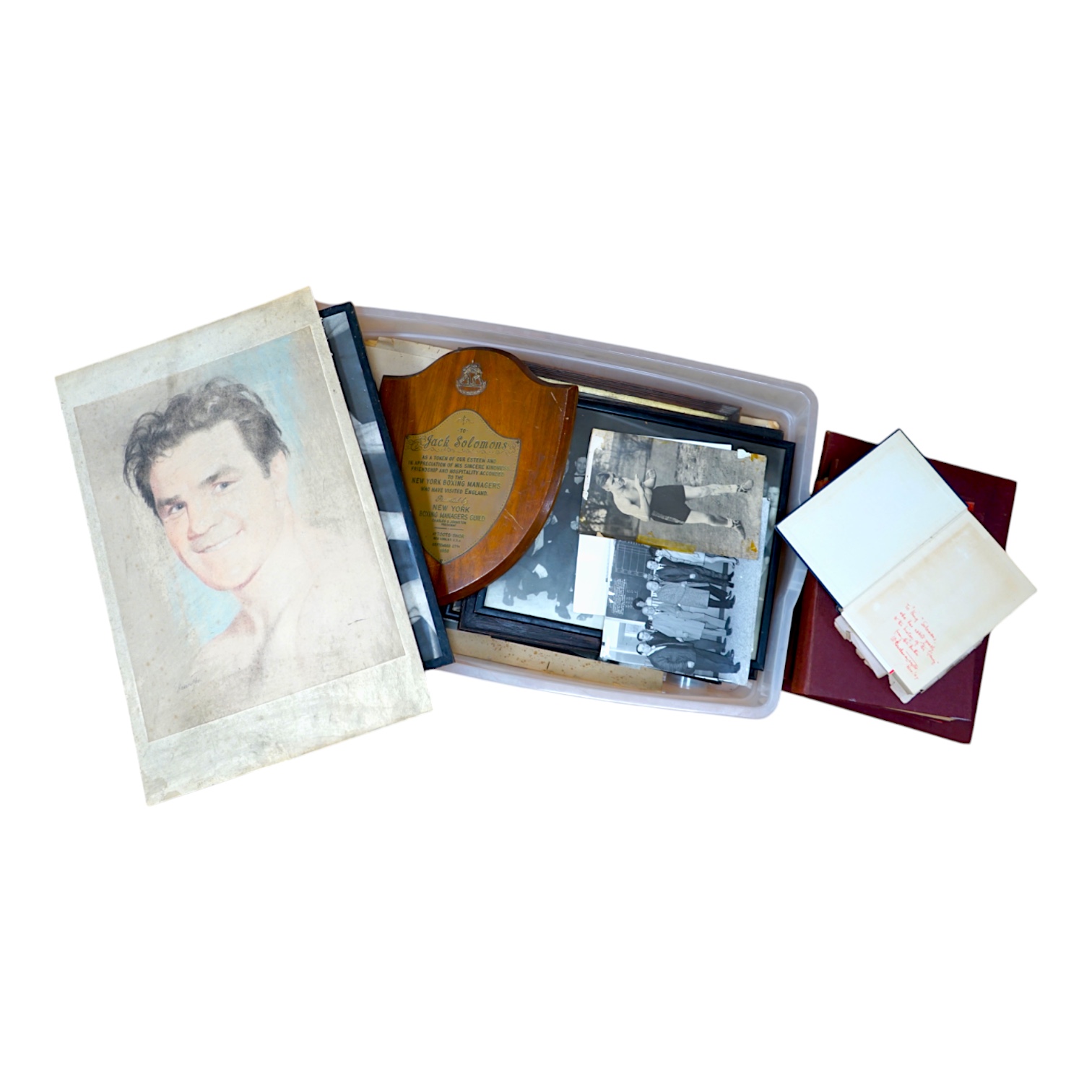 A collection of Jack Solomans boxing promo ephemera to include a shield shaped plaque, black and white photographs, books and a pastel portrait. Condition - varies